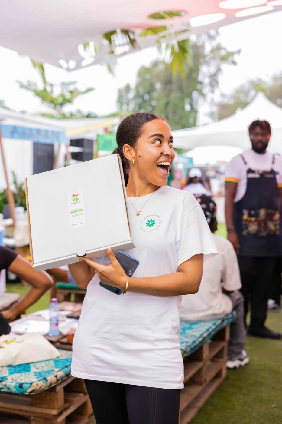 Guest celebrating with pizza box